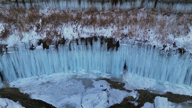 4K drone footage of a frozen waterfall in winter in Mangystau, Kazakhstan. Icy cascades and frozen water at Tamshaly tract near Fort Shevchenko. Cold winter natural landscape, wild untouched nature
