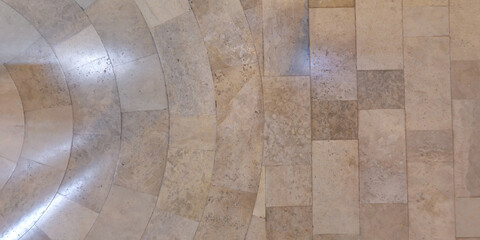 Obraz premium top view of surface of pedestrian path with paving slabs with the border of light and shadow