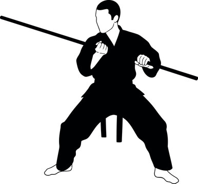 Martial arts practitioner demonstrating a powerful stance with a long staff