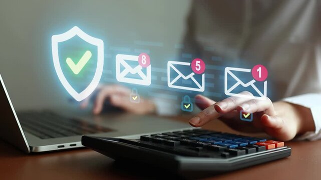 Working on a laptop with a calculator while managing email notifications and ensuring secure communication during a busy workday.