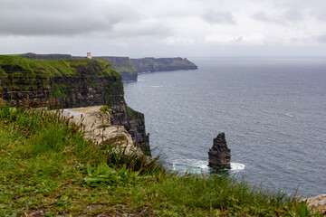 a rainy and stormy summer day at the famous cliffs of moher in the irish County Clare. A View to the famous O'Briens tower next to the cliffs. 