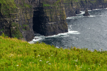 a rainy and stormy summer day at the famous cliffs of moher in the irish County Clare