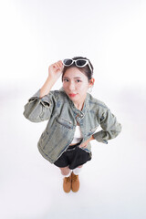 Stylish Woman Posing: A fashionable woman in stylish attire gazes directly at the camera. Her sunglasses held casually, her confident demeanor exudes a sense of modern chic.