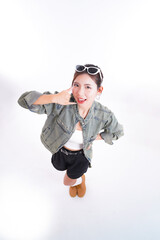 Confident Woman in Fashion: A stylish woman in casual attire, striking a playful pose. Expressing confidence and fashion-forwardness, perfect for lifestyle and beauty-related content.
