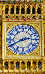 Obraz premium Big Ben clock tower on a sunny day with a blue-grey sky, close-up.