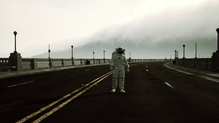 An astronaut stands alone on a deserted road, surrounded by a thick fog. Street lamps line the bridge, creating a surreal atmosphere. The quietness evokes a sense of wonder. © icetray