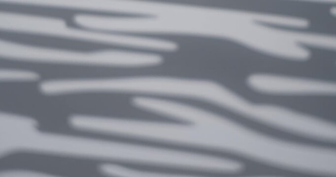 Blurred black and white zebra stripes created by a gobo projector, forming a soft abstract pattern ideal for backgrounds and modern design. Slow motion.
