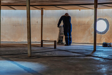 Fototapeta premium Male worker inspection floorscan tank