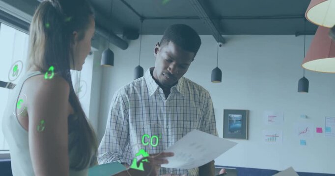 Animation of eco icons over diverse business people in office