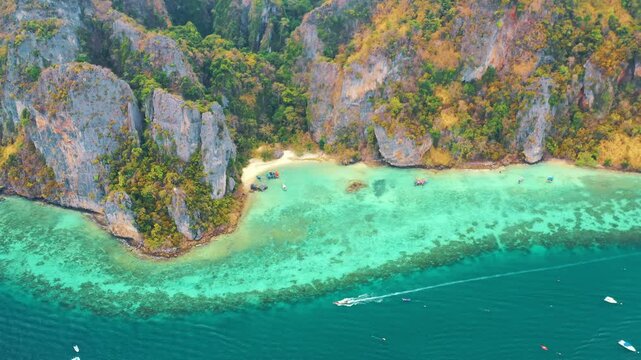 Drone flying over the clear blue waters and limestone hills in tropical sea. One of the most beautiful wonders in the world. Phi Phi Island, Thailand. Paradise ocean video. Travel and holiday concept