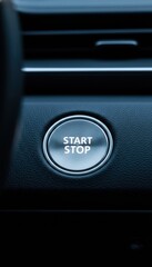 Vertical Close up of Silver Engine Start Stop Button on Dark Leather Dashboard with Blue Ambient Lighting and Sleek Interior Design