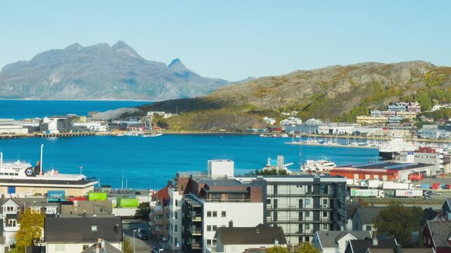 Bodo, Norway. View of the marina in the city center of Bodo, Norway with a fjord and a mountain in the background. Time-lapse during a sunny winter day, panning video