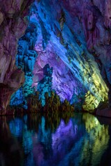 Reed flute cave limestone formations reflecting in water