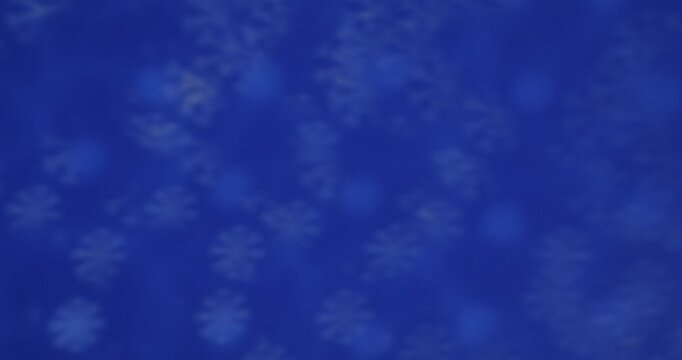 Blurred blue bokeh lights creating a serene and dreamy atmosphere, perfect for backgrounds and overlays. Slow motion.