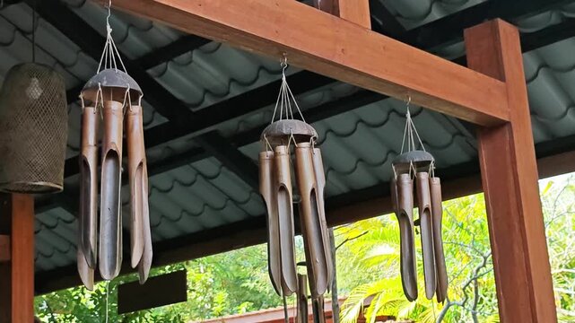 Handcrafted bamboo wind chimes swaying gently in the breeze.