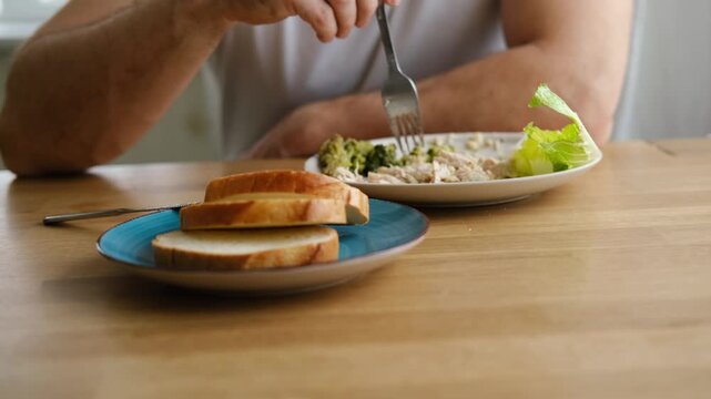 6 years old boy eats instant noodle from box. Child is eating Asian ramen. Lunch time. A good appetite. Tasty children food. Close-up portrait. Carbs dinner. Fast food. Kid eating by himself with fork