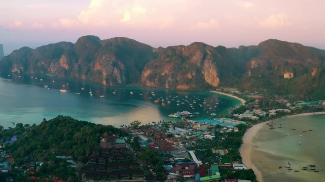 Drone flying over the clear blue waters and limestone hills in tropical sea. One of the most beautiful wonders in the world. Phi Phi Island, Thailand. Paradise ocean video. Travel and holiday concept