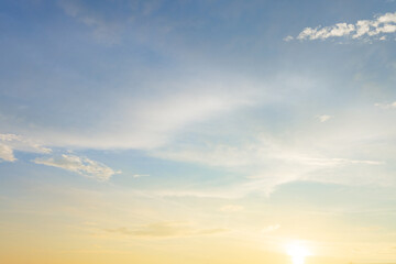 Beautiful sunset sky with soft orange and purple clouds background,Panoramic view of dramatic evening sky during sunset. Vibrant orange light on the horizon blending with soft purple and blue tones.