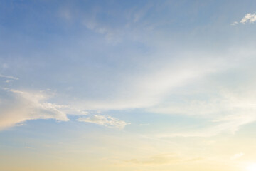 Obraz premium Beautiful sunset sky with soft orange and purple clouds background,Panoramic view of dramatic evening sky during sunset. Vibrant orange light on the horizon blending with soft purple and blue tones.