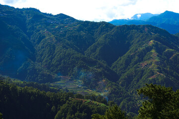 Terraced Mountain Landscape with Forested Hills and Rural Farmland