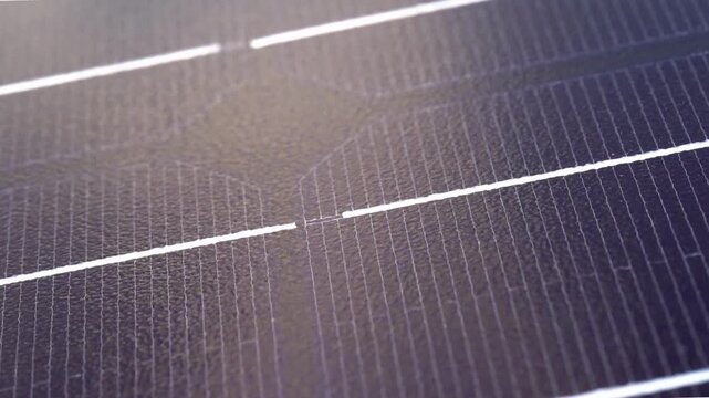 Macro Texture of Polycrystalline Silicon Solar Cell showing Photovoltaic Wafer Grid and Sun Flare Reflection for Clean Energy Technology
