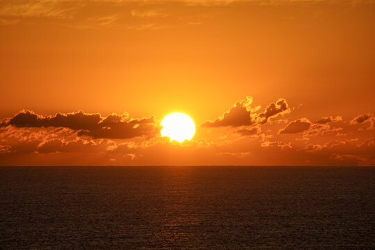 Beautiful sunset over the ocean with sun path reflection on water