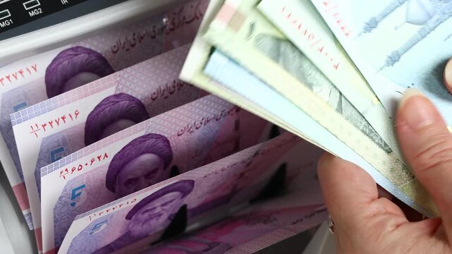 Iran is printing more money. Financial crisis. New Iranian rials in a money counter. Financial and business concept.