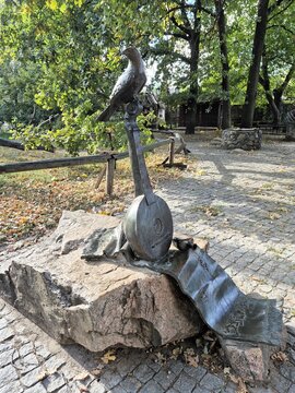 Bronze sculpture of a kobza (the national musical instrument of Ukraine) and a bird of prey on it.
