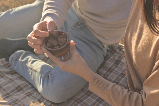A Moroccan girl offering a European boy some dates. Lovers enjoying some delicious dates.