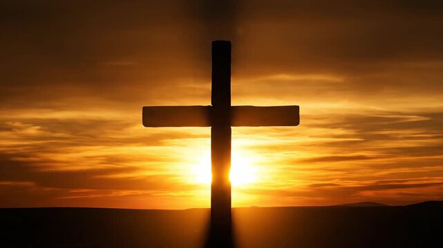Silhouette of a Christian Cross Against a Dramatic Sunset with Sun Rays
