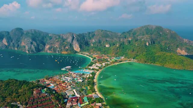 Drone flying over the clear blue waters and limestone hills in tropical sea. One of the most beautiful wonders in the world. Phi Phi Island, Thailand. Paradise ocean video. Travel and holiday concept