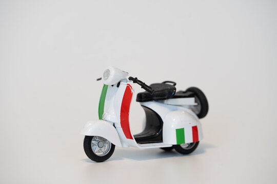 Bucharest Romania 1 February 2026.White Vespa toy scooter with Italian flag design on a white background, perfect for travel or Italy-themed concepts