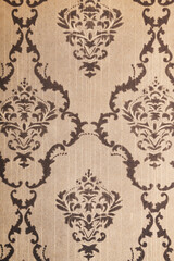 Old wallpaper on the wall. Old wallpaper for texture or background.