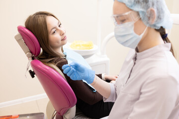 Fototapeta premium a dentist treats a patient's teeth.Dentist and patient at modern medical center.