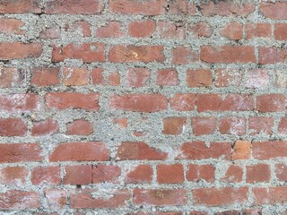 Weathered Red Brick Wall Texture - Detailed Background of Aged Clay Bricks and Rough Mortar for Industrial and Rustic Construction Design