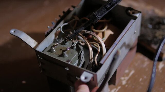 repair of a microcircuit with a soldering iron and a tweezers close-up