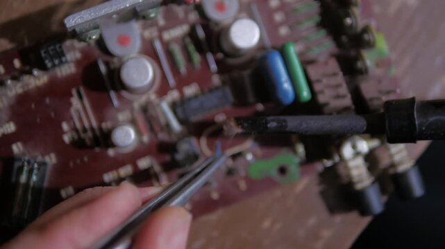 repairing a microphone amplifier using a soldering iron