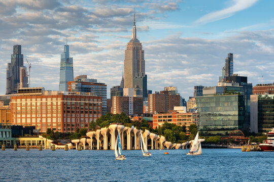New York City, NY, USA &ndash; August 19, 2025: Midtown Manhattan skyline with the Empire State Building, One Vanderbilt, Little Island, and sailboats on the Hudson River