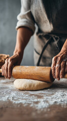 Close-up hands rolling smooth dough with wooden rolling pin, clean minimalist kitchen background