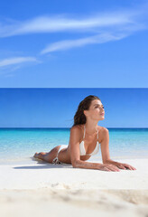 Woman on the beach in white bikini