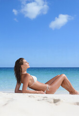 Woman on the beach in white bikini