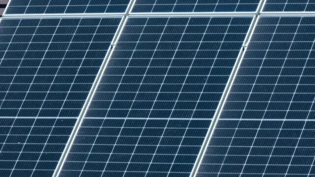 Macro Texture of Polycrystalline Silicon Solar Cell showing Photovoltaic Wafer Grid and Sun Flare Reflection for Clean Energy Technology