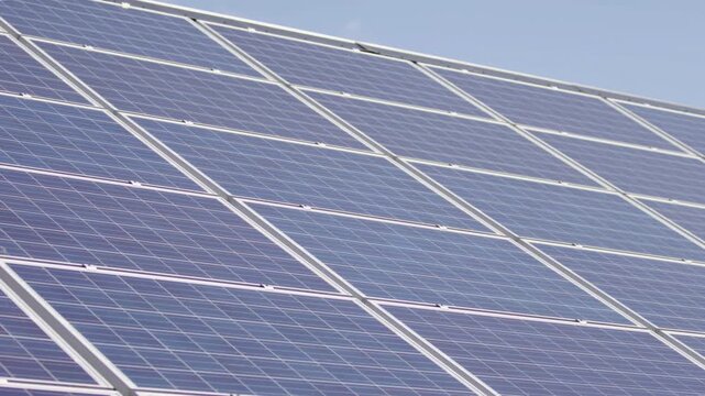 Macro Texture of Polycrystalline Silicon Solar Cell showing Photovoltaic Wafer Grid and Sun Flare Reflection for Clean Energy Technology