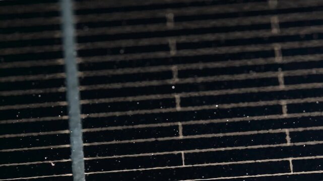 Macro Texture of Polycrystalline Silicon Solar Cell showing Photovoltaic Wafer Grid and Sun Flare Reflection for Clean Energy Technology
