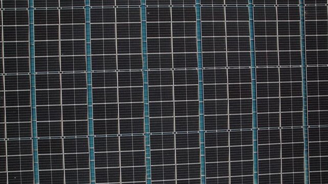 Macro Texture of Polycrystalline Silicon Solar Cell showing Photovoltaic Wafer Grid and Sun Flare Reflection for Clean Energy Technology