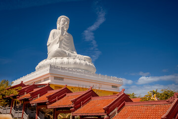 Buddha statue surrounded at Chua Hue Chieu temple in Kontum, Vietnam © Olga Khoroshunova