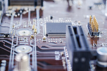 Close-up view of a computer motherboard with intricate circuitry and a central processor chip