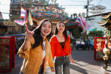Asian friends traveling and exploring old town street © Parichat