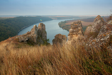 Breathtaking panoramic view of the Dniester River and Shyshkovi Horby hills in Nagoryany, Ukraine. High angle aerial view of the picturesque Dniester canyon with unique limestone rock formations .