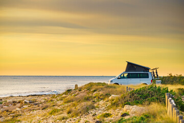 Van camper with tent on roof top camp on nature © anetlanda